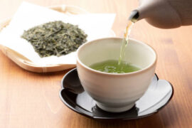 Warm Green Tea On A Wooden Table.