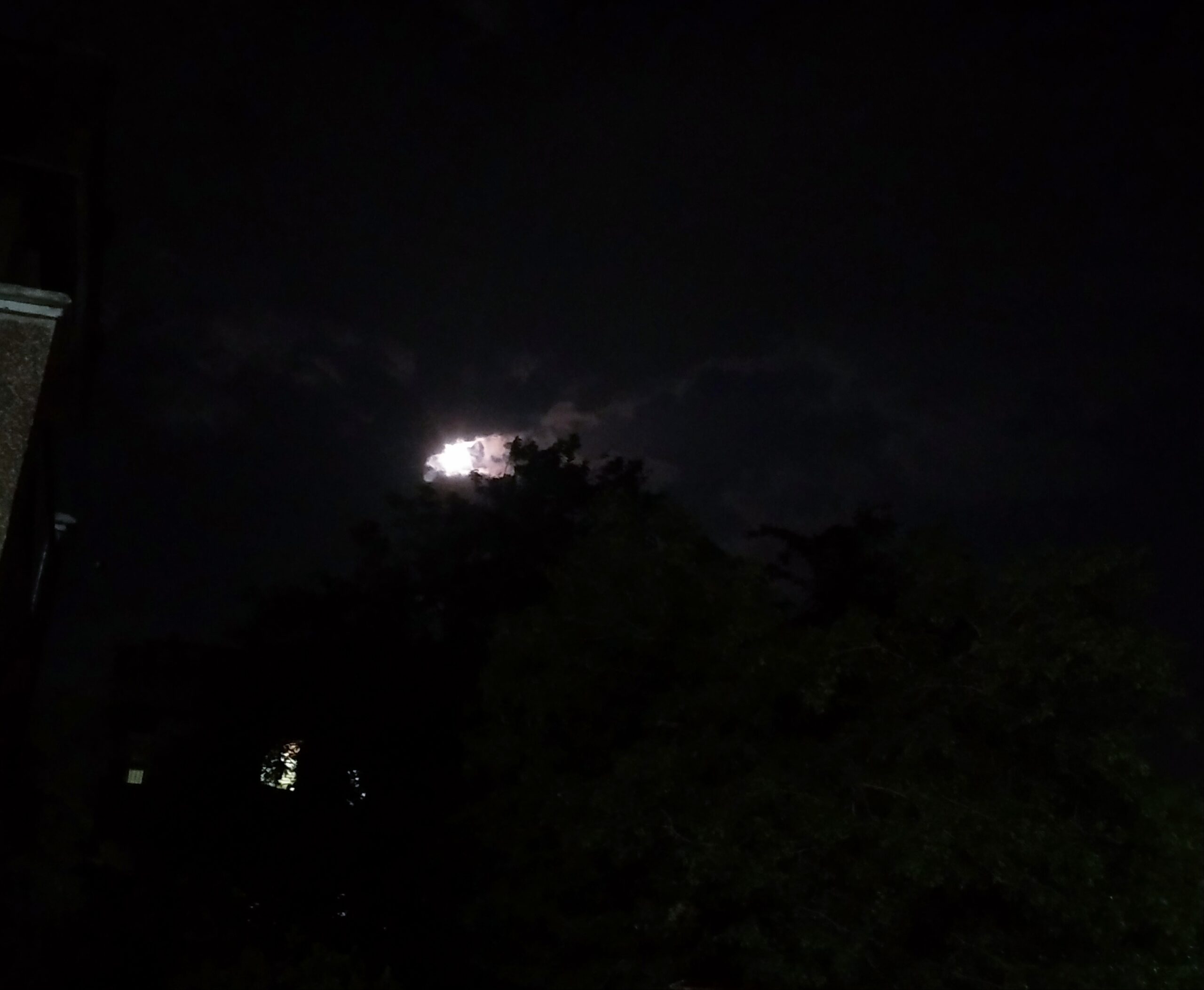 Night View And The Moon Behind Clouds
